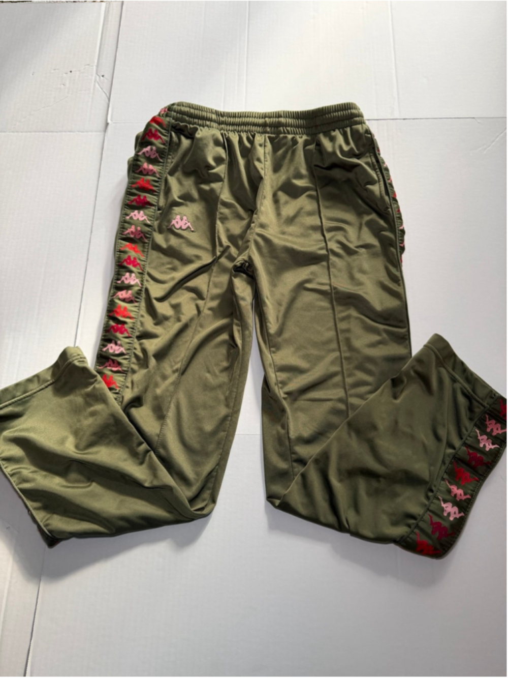 Olive green Kappa 222 Banda track pants with pink and red Omini logo down side